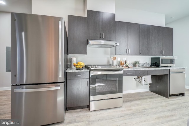 kitchen featuring light stone countertops, stainless steel appliances, and light hardwood / wood-style floors