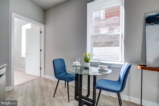 dining area with light hardwood / wood-style floors