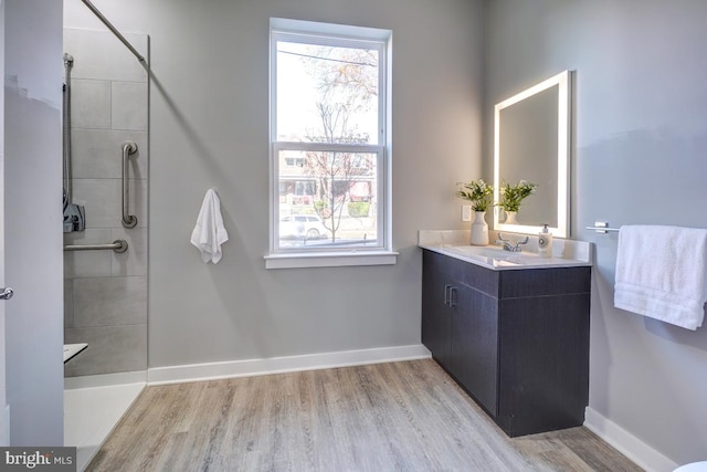 bathroom featuring a wealth of natural light, wood-type flooring, and large vanity