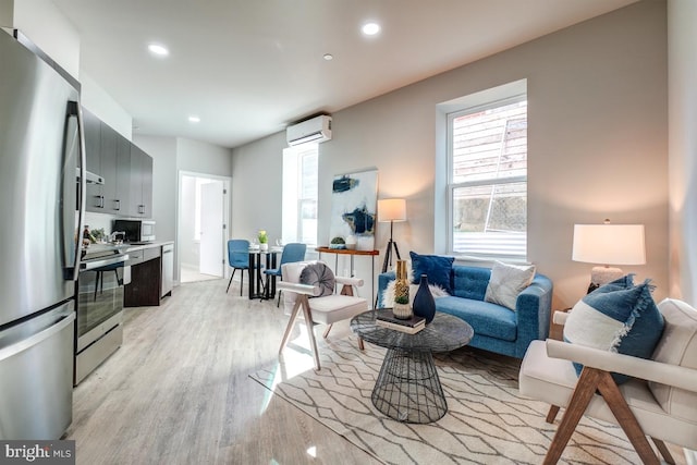 living room with light wood-type flooring and a wall mounted air conditioner