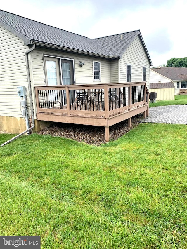 back of house featuring a yard and a deck