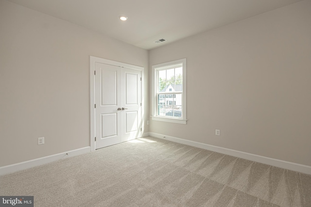 unfurnished room featuring carpet