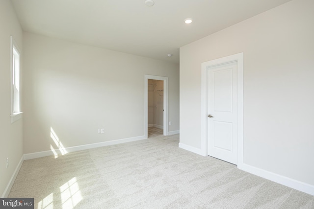 spare room with light colored carpet and plenty of natural light