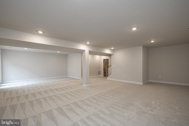 basement featuring light colored carpet