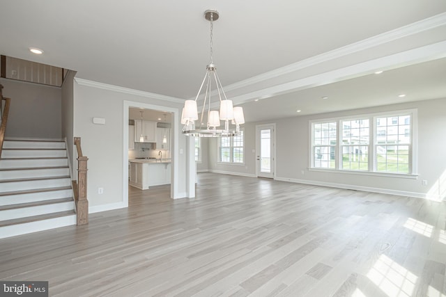 interior space with ornamental molding, sink, light hardwood / wood-style floors, and a notable chandelier