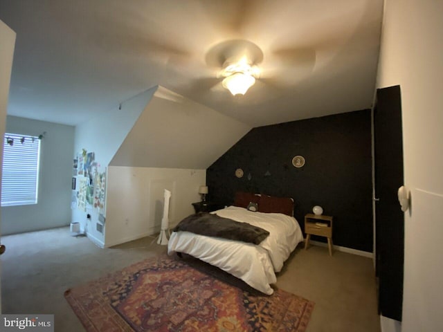 bedroom with ceiling fan, light colored carpet, and vaulted ceiling