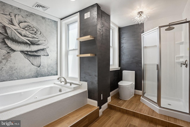 bathroom featuring wood-type flooring, separate shower and tub, and toilet