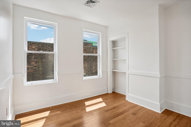 spare room with light hardwood / wood-style floors