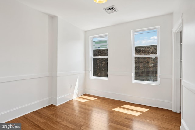 spare room with hardwood / wood-style flooring