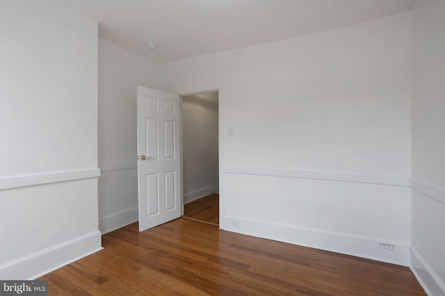 spare room with dark hardwood / wood-style flooring