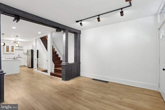 interior space featuring light hardwood / wood-style flooring and a chandelier