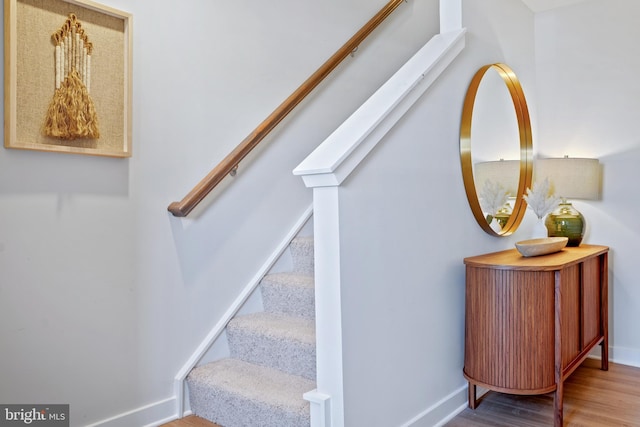 stairs featuring hardwood / wood-style flooring