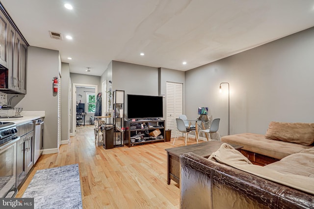 living room with light hardwood / wood-style flooring