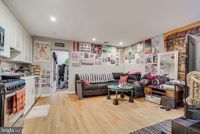 living room with light hardwood / wood-style flooring