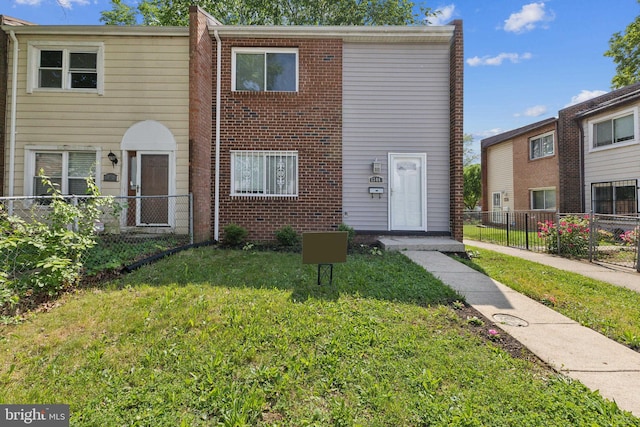 view of property featuring a front lawn