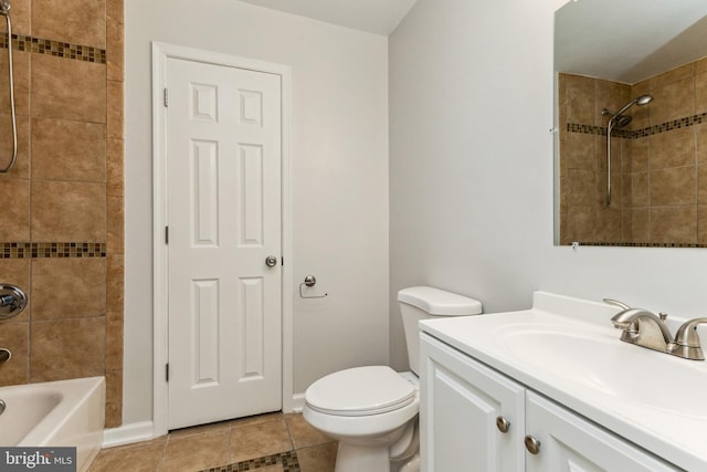 full bathroom featuring tile flooring, tiled shower / bath, vanity, and toilet