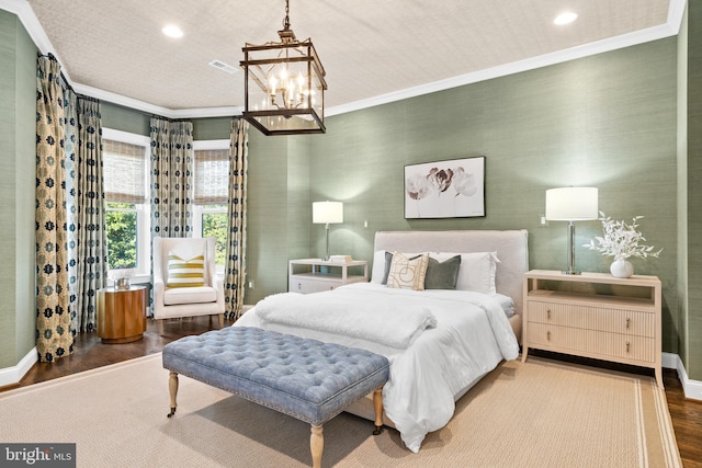 bedroom featuring a chandelier, dark hardwood / wood-style floors, and ornamental molding