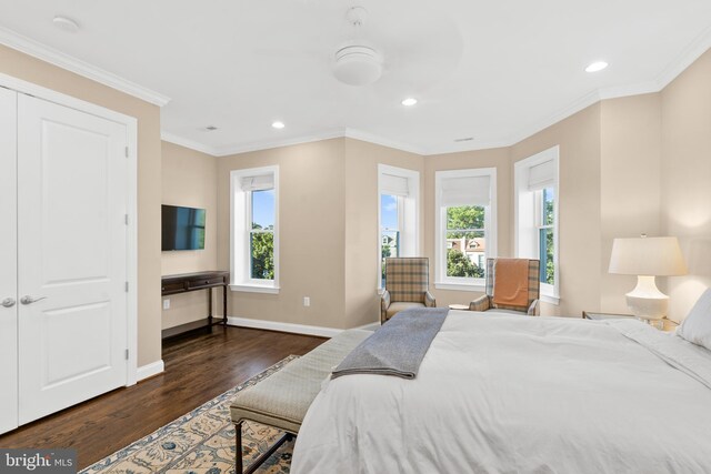 bedroom with dark hardwood / wood-style floors, a closet, and crown molding