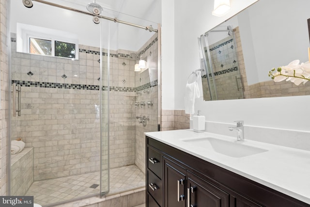 bathroom featuring vanity and an enclosed shower