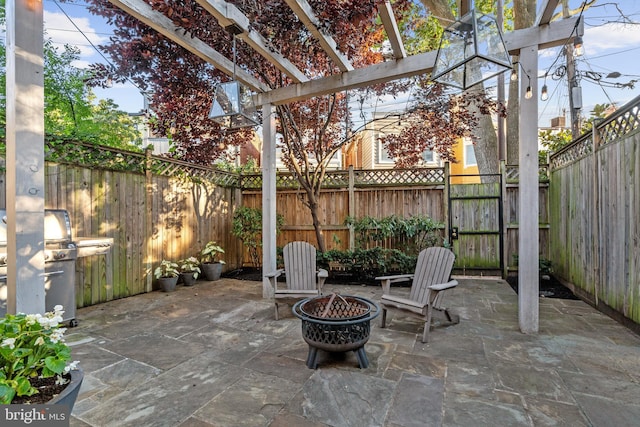 view of patio / terrace with a pergola, a fire pit, and grilling area