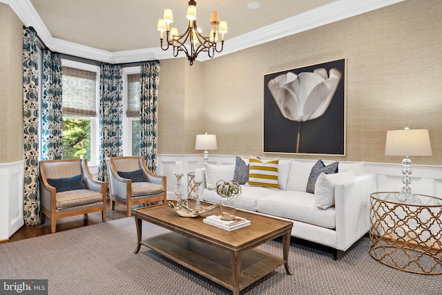 living room featuring hardwood / wood-style floors, ornamental molding, and an inviting chandelier