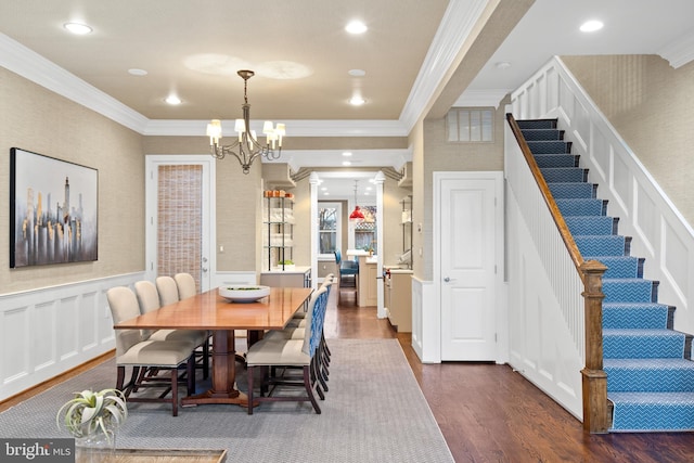 dining room with an inviting chandelier, dark hardwood / wood-style floors, and ornamental molding