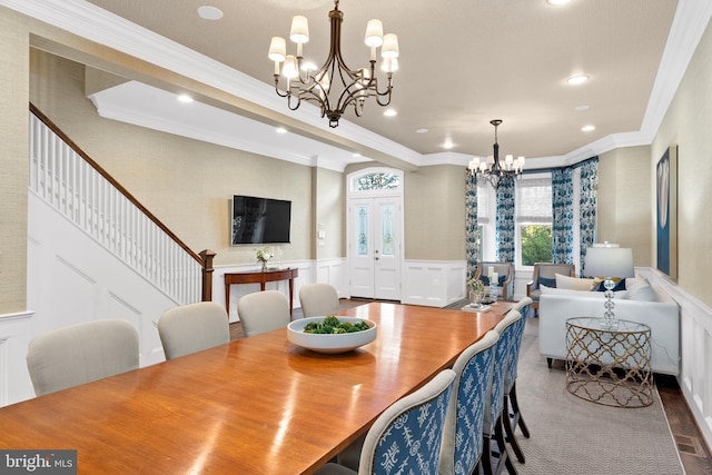 dining area with ornamental molding and a chandelier