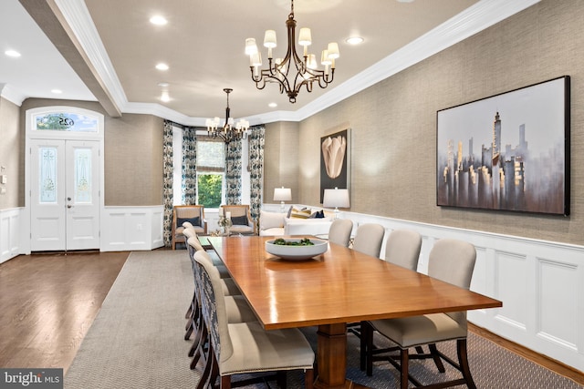 dining room featuring a notable chandelier, dark hardwood / wood-style flooring, and ornamental molding