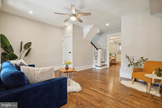 living room with hardwood / wood-style floors and ceiling fan