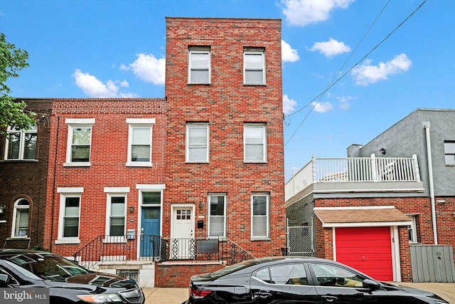 townhome / multi-family property featuring a garage and a balcony