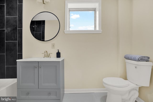 bathroom featuring tile flooring, vanity, and toilet