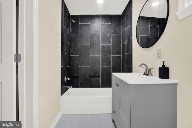 bathroom with tile flooring, vanity, and tiled shower / bath combo