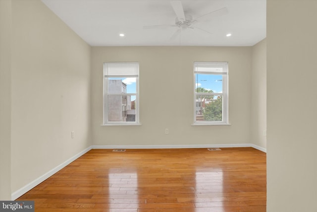 unfurnished room with ceiling fan and hardwood / wood-style floors