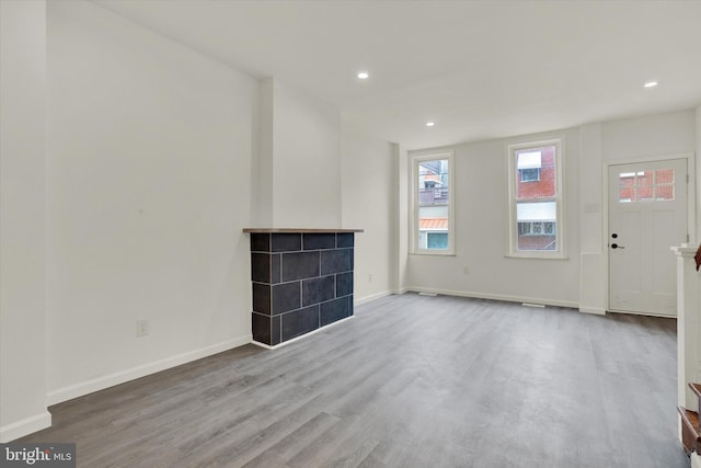 unfurnished living room with hardwood / wood-style floors and a fireplace