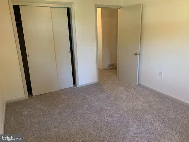 unfurnished bedroom with carpet flooring and a closet