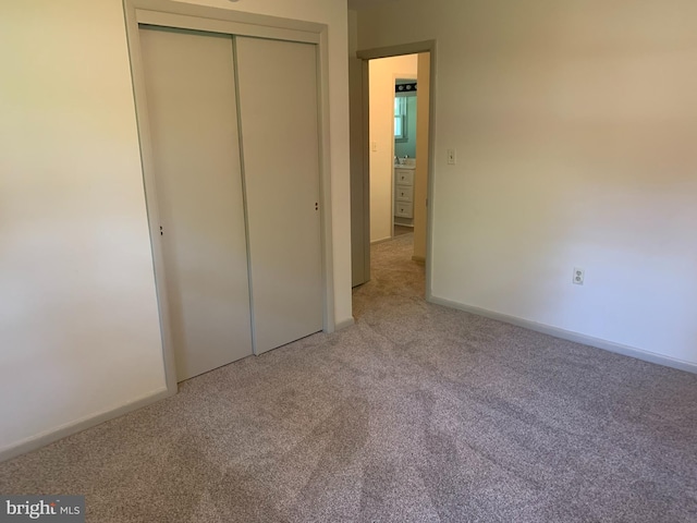 unfurnished bedroom with carpet and a closet