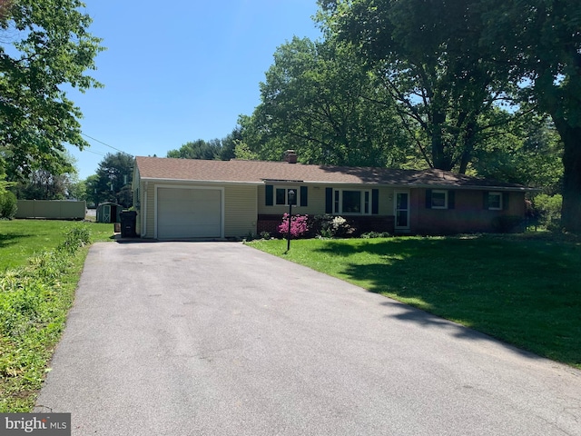 single story home with a garage and a front yard