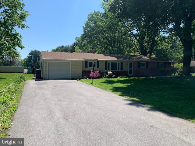 single story home featuring a front yard and a garage