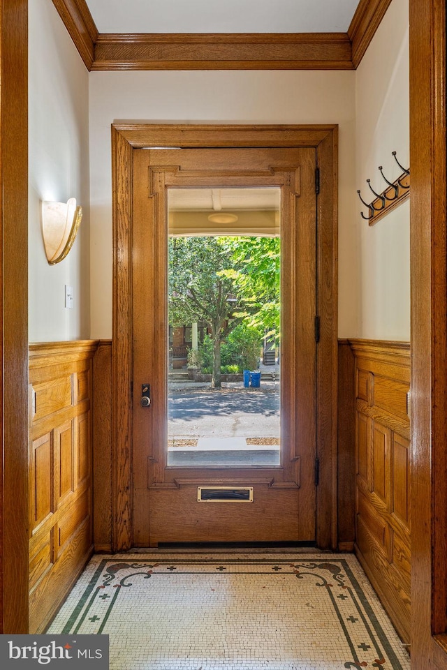 doorway with plenty of natural light and crown molding