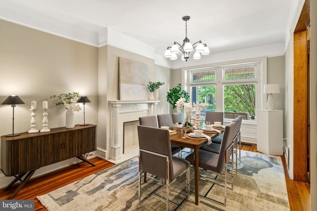 dining room with hardwood / wood-style flooring and a notable chandelier