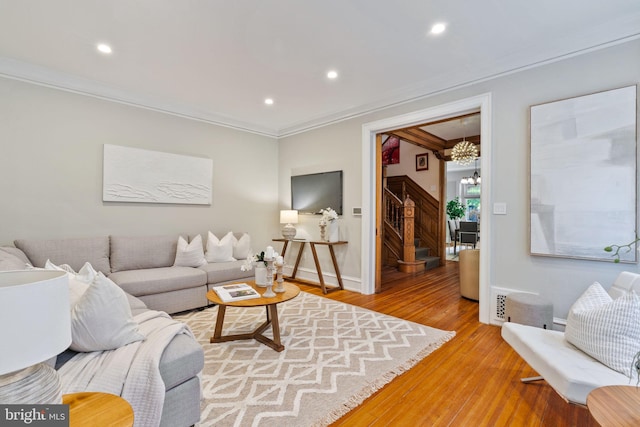 living room featuring light hardwood / wood-style floors and ornamental molding