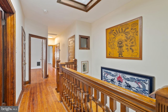 hall with hardwood / wood-style flooring