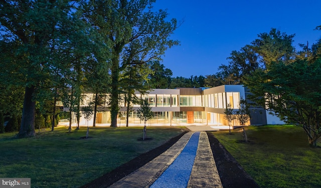 rear view of property featuring a yard