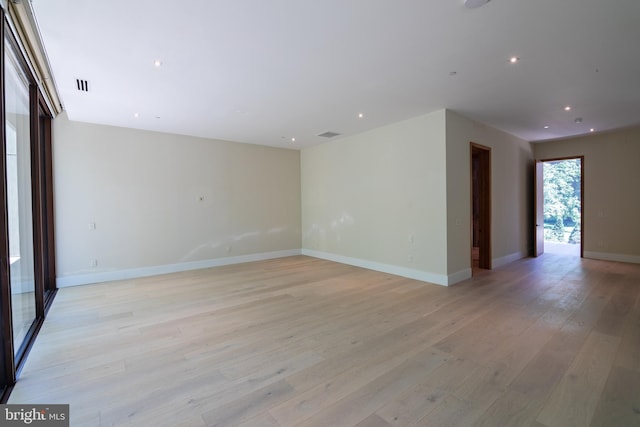 spare room featuring light wood-type flooring