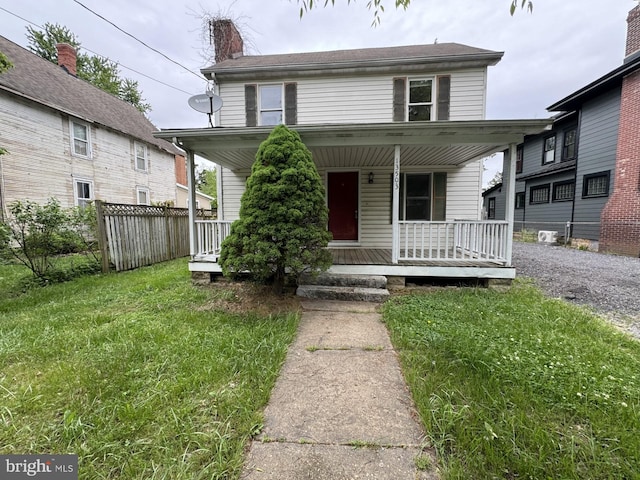 view of front of home featuring covered porch and a front yard