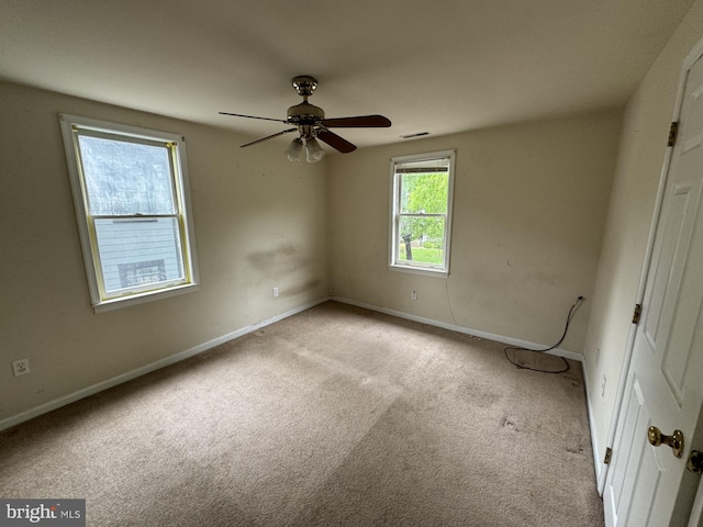 unfurnished room featuring light carpet and ceiling fan