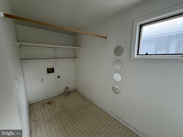 clothes washing area with hookup for a gas dryer, light tile flooring, hookup for a washing machine, and electric dryer hookup