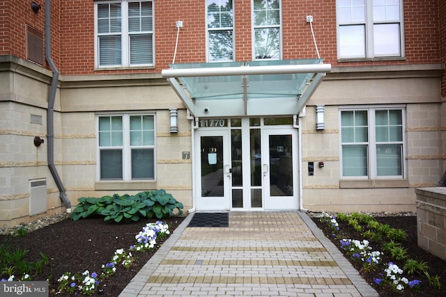 view of exterior entry featuring french doors