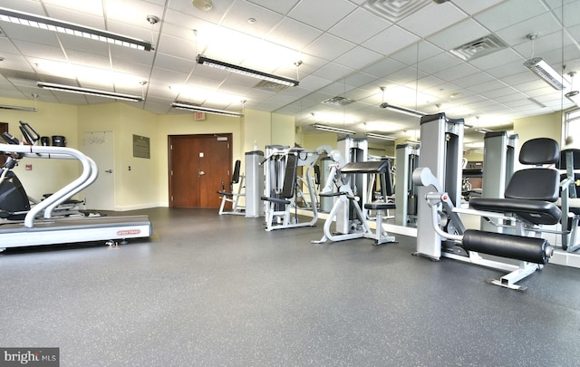 workout area featuring a paneled ceiling