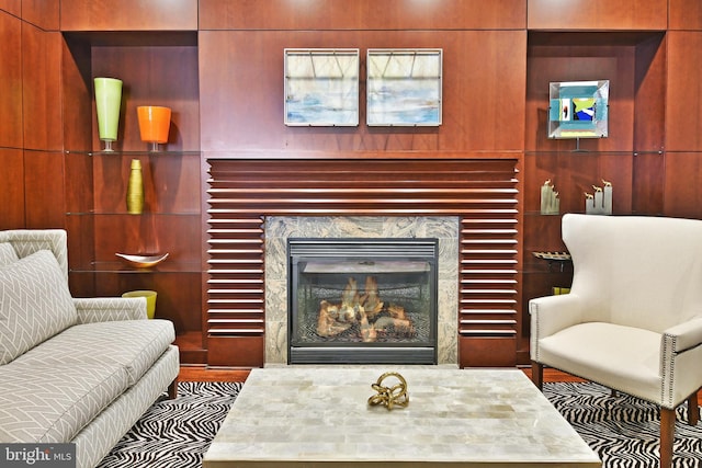 interior space with built in features, a fireplace, and wood walls